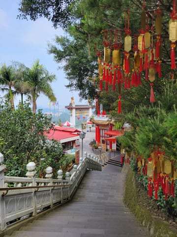 Steps descending through red decorations at the Zhinan Temple Complex