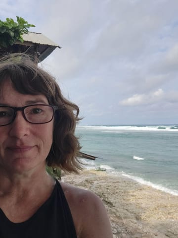 Stacy at Bingin Beach with the ocean behind her