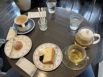 Coffee, tea, and slices of cake arranged on a cafe table in Tokyo