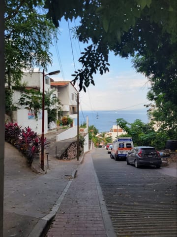 A steep downhill street view toward the ocean in Puerto Vallarta