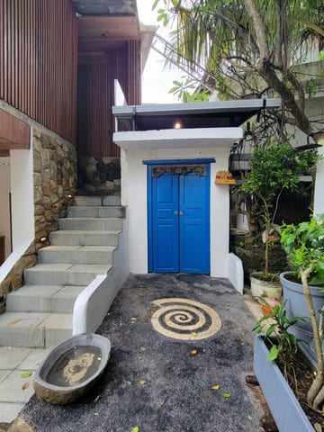 Bright blue double doors beside another flight of stairs