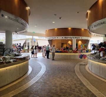 Curved stalls and warm lighting inside Larnaca's modern market hall
