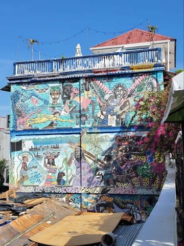 A colorful mural painted across the side of a Casco Viejo building