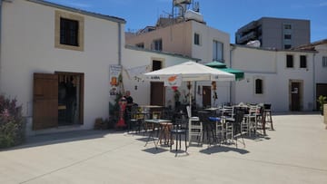 A café terrace in a quiet whitewashed square in Larnaca