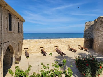 The stone courtyard of Larnaca Fort overlooking the sea