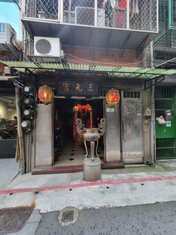 A small neighborhood shrine tucked between buildings in Taipei