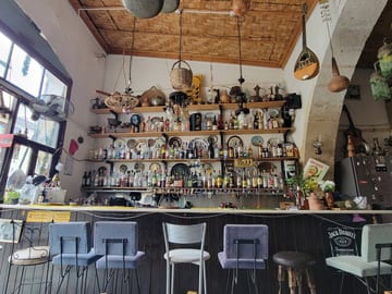 The colorful bar and shelves inside a Larnaca cafe known for Cypriot coffee