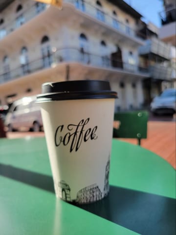 A takeaway coffee cup on a cafe table in Casco Viejo
